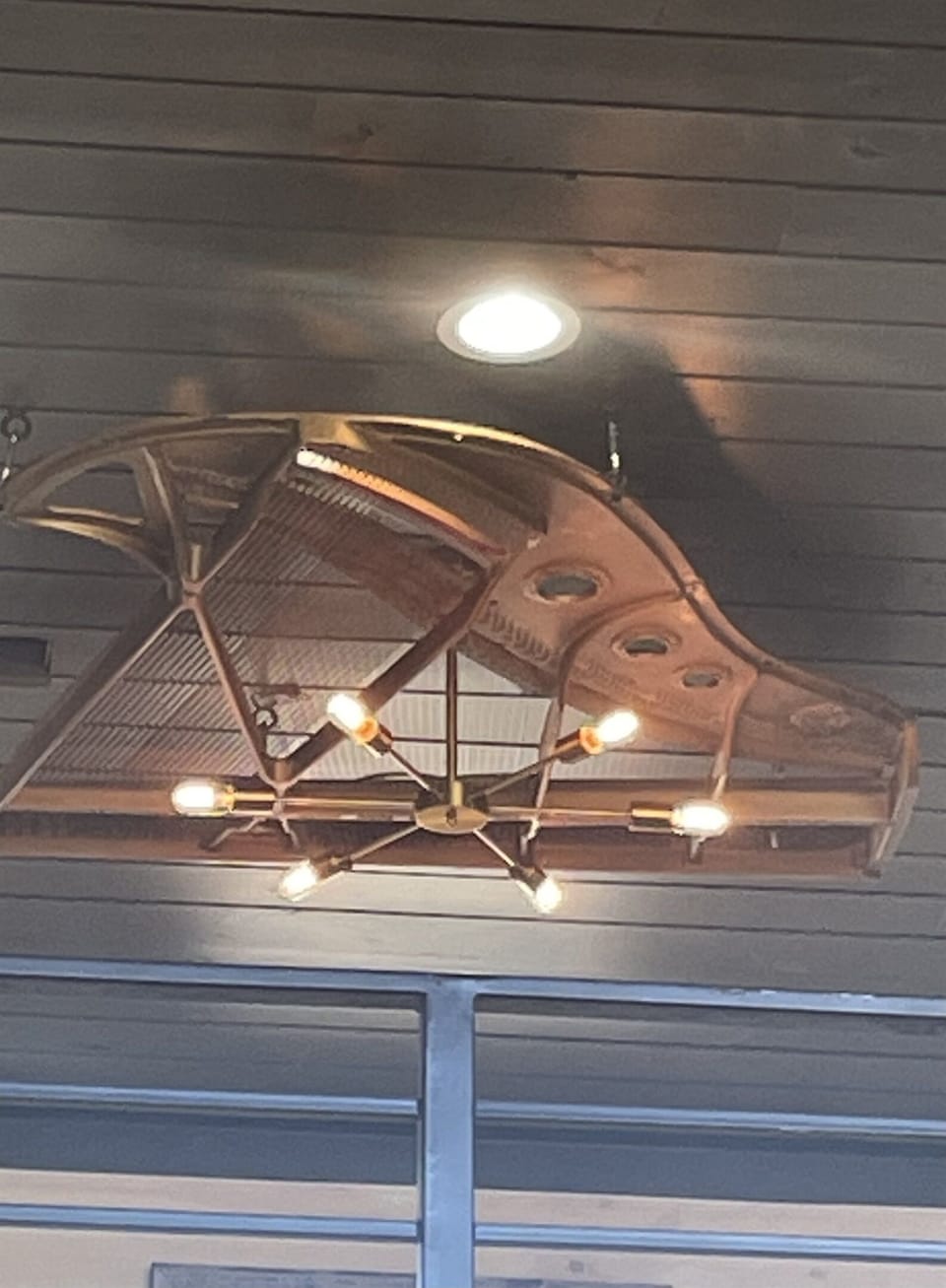 The 118-year-old piano makes its second appearance with a light over the pool table constructed from the piano’s hammers and strings.