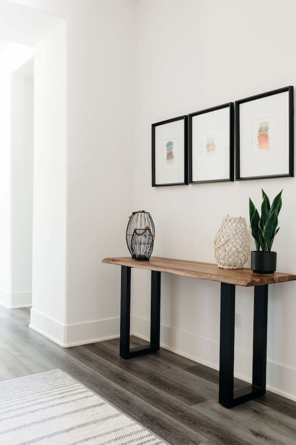 Entry console w/ decor accents & greenery, adding a warm welcome touch