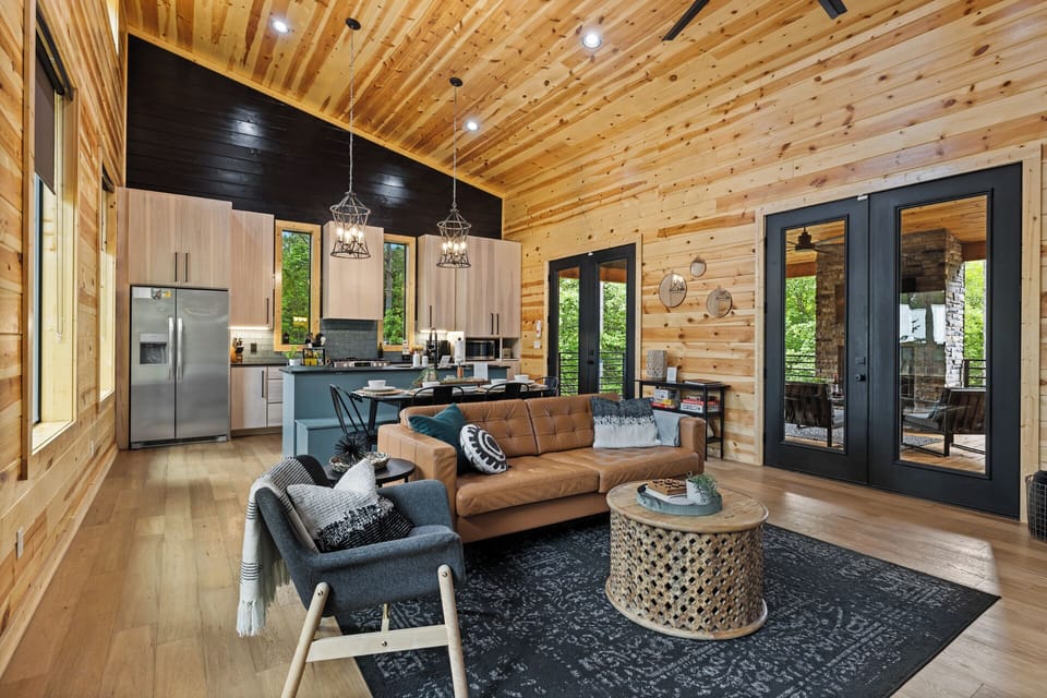 Cozy cabin retreat for two: Enjoy the seamless blend of dining, living, and kitchen spaces in an open, inviting layout. 