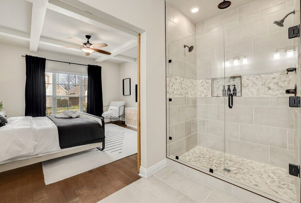 The Master bathroom can be found through large, wooden barn-style doors.
