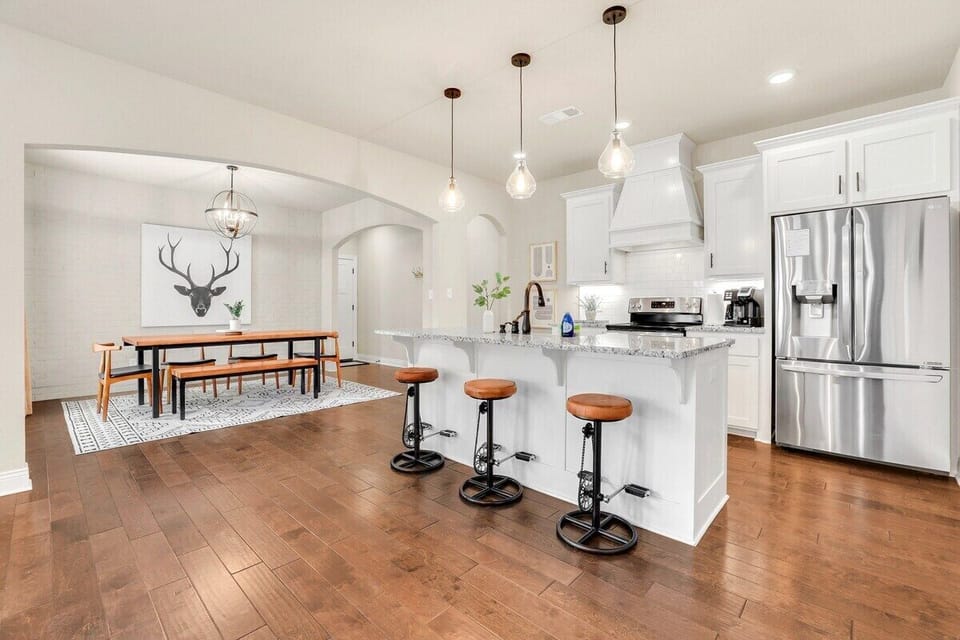 Our granite island and three barstools sit in the center of this space.