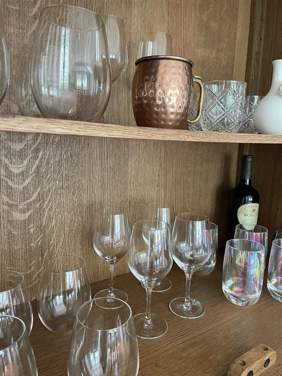 Plenty of glasses and dishes, fully stocked 