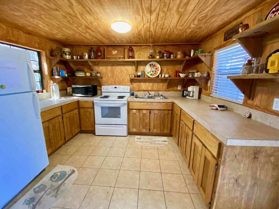 On the Rocks - A super rustic river shack kitchen decorated with antiques.