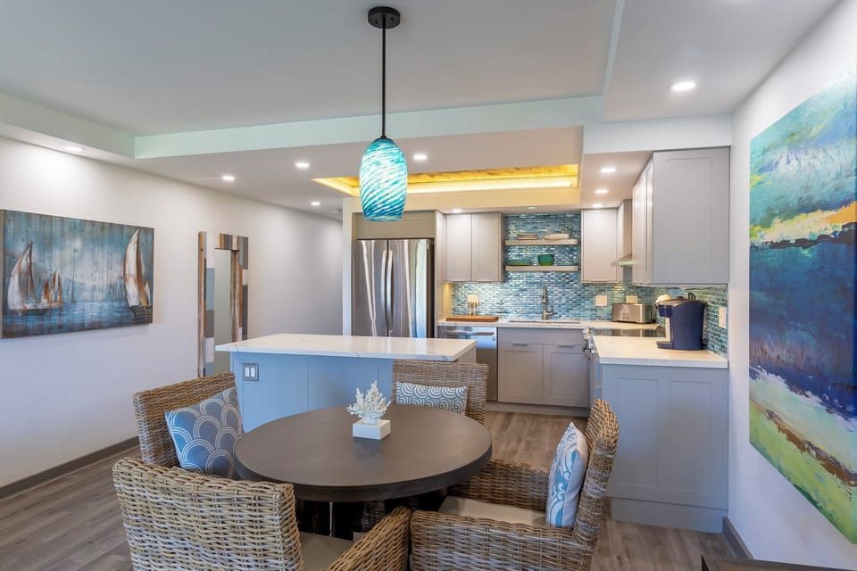 Step into this sun-filled open living space where the full kitchen meets coastal-inspired comfort. Modern appliances, warm wood floors, and beach-inspired art create your home away from home.