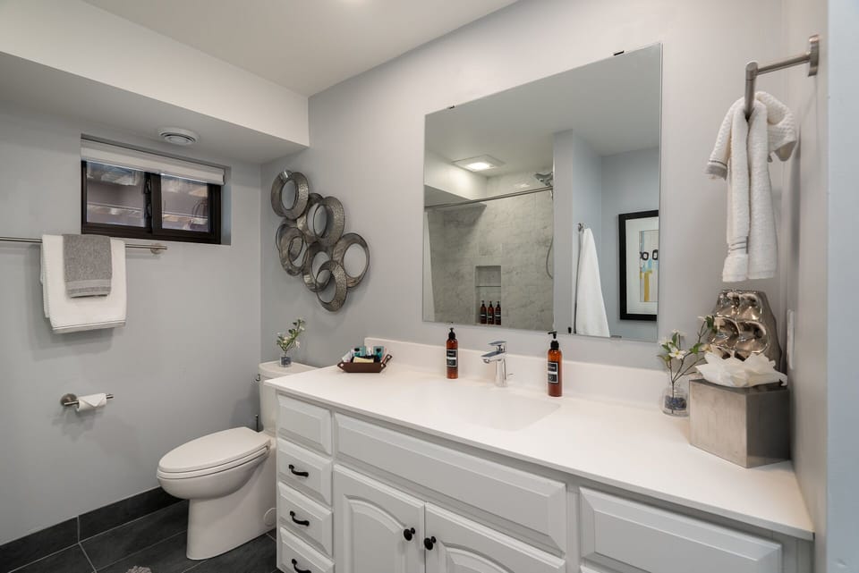 Step into your elegantly appointed bathroom featuring marble walk-in shower, spacious vanity, and luxury amenities for ultimate comfort.