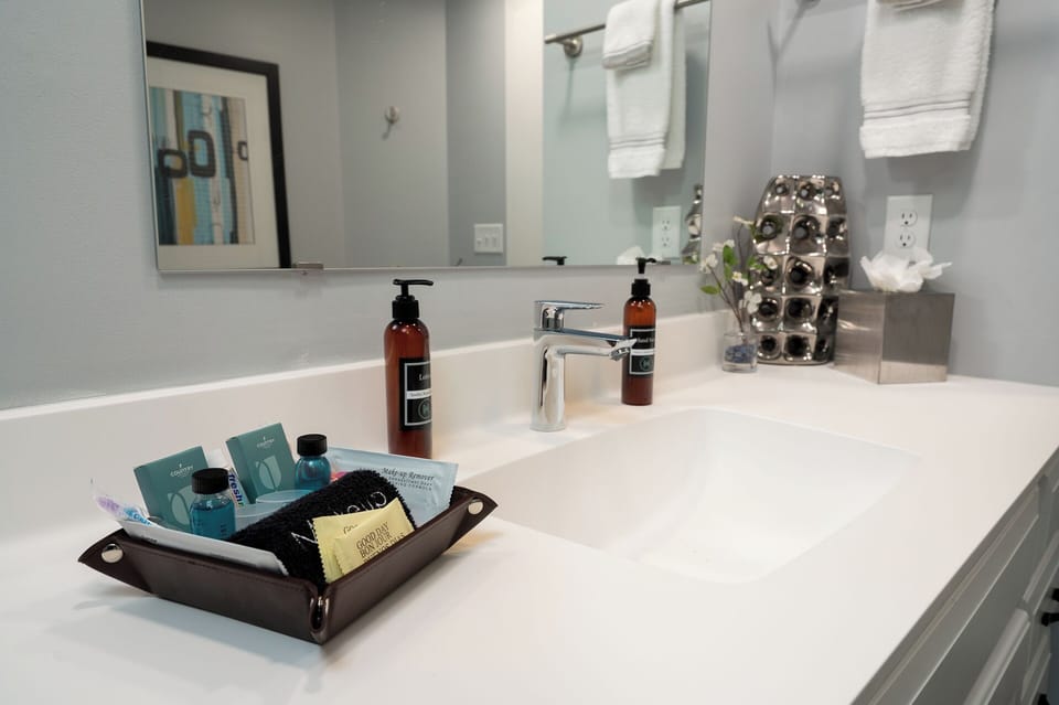 Fresh towels await while premium amenities and thoughtful touches make your morning routine feel luxurious in this spotless, well-appointed bathroom.