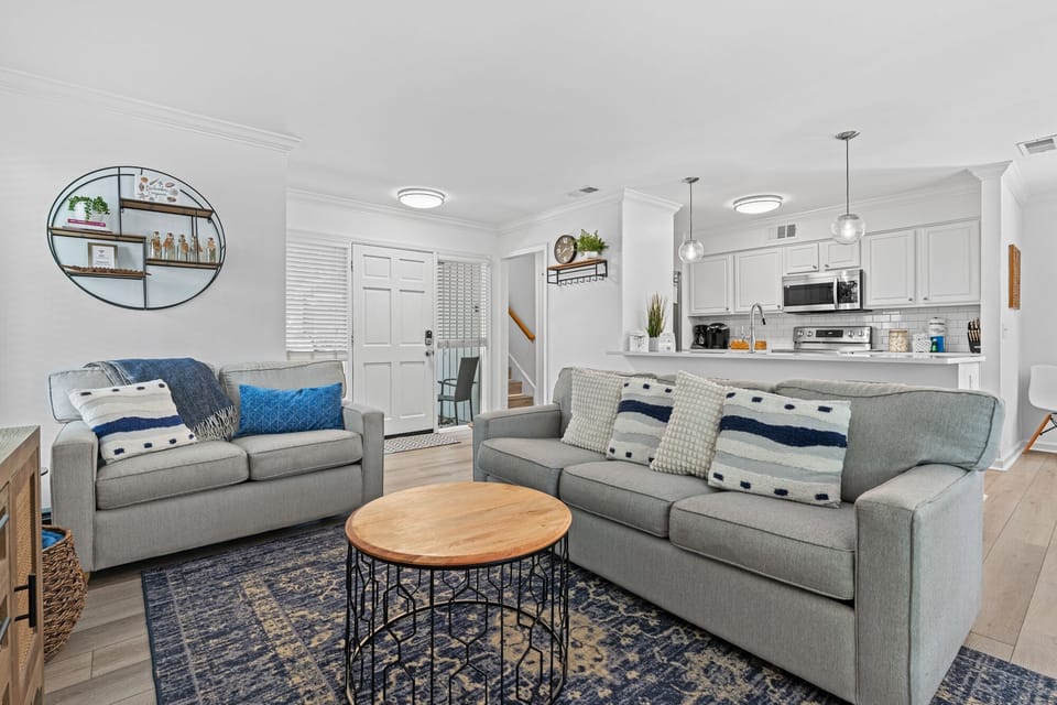 Living room with open concept to kitchen, dining and sliders to backyard