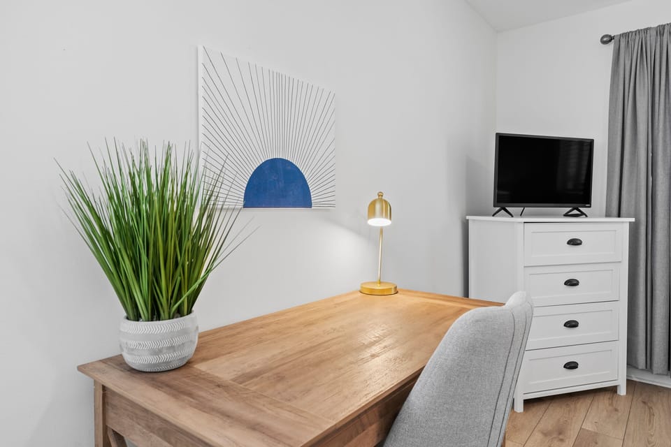 Guest bedroom with queen bed and desk area