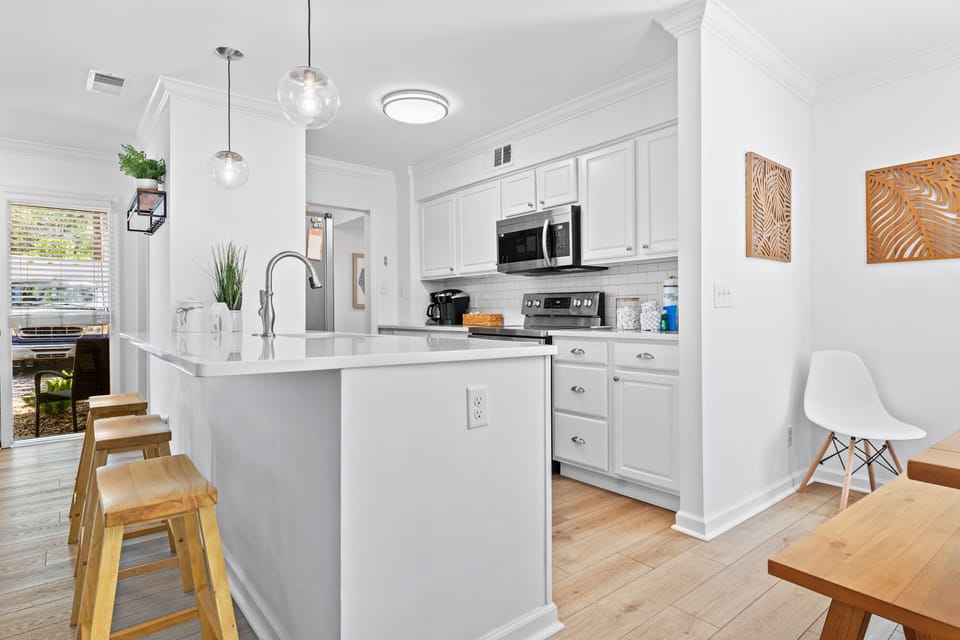 Fully equipped kitchen with barstools at counter