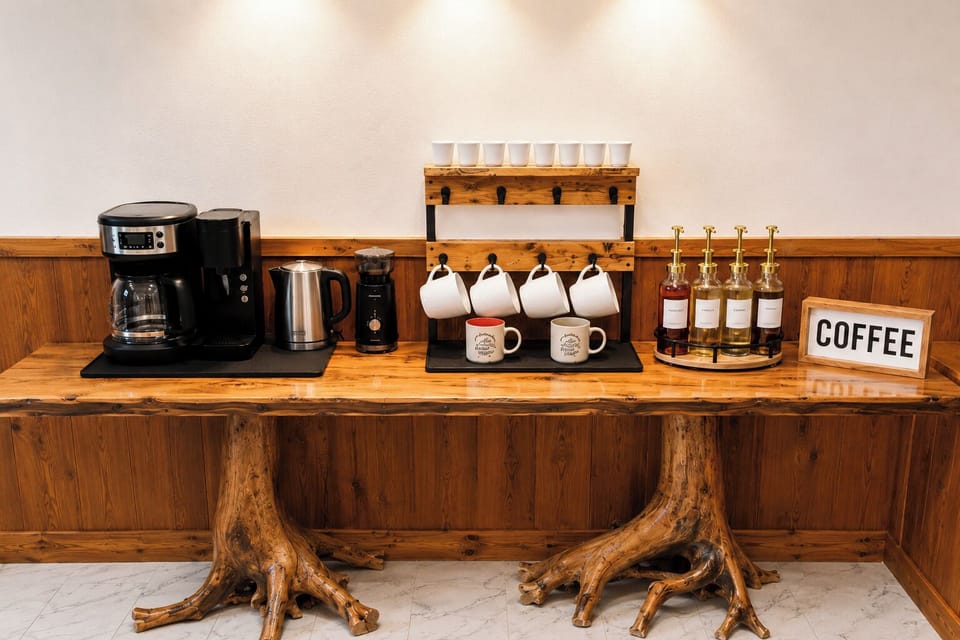 coffee bar with Keurig and drip maker, coffee bean grinder, tea Kettle, flavored coffee syrups