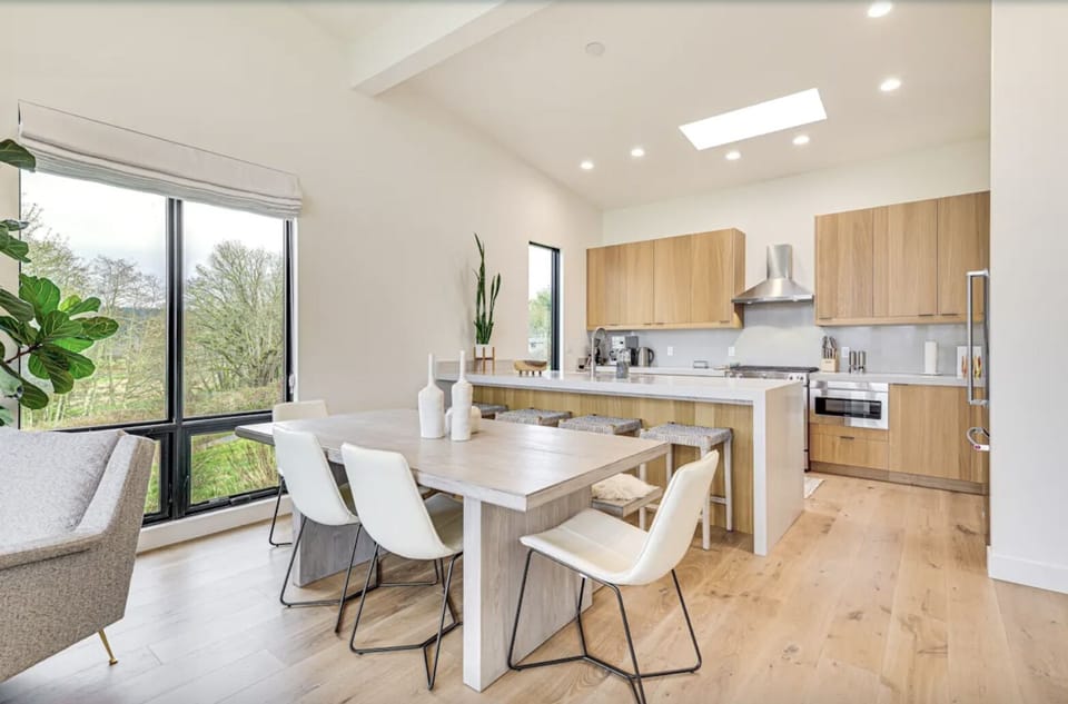 Light-filled, open concept Living, Dining and Kitchen. High ceilings & windows.
