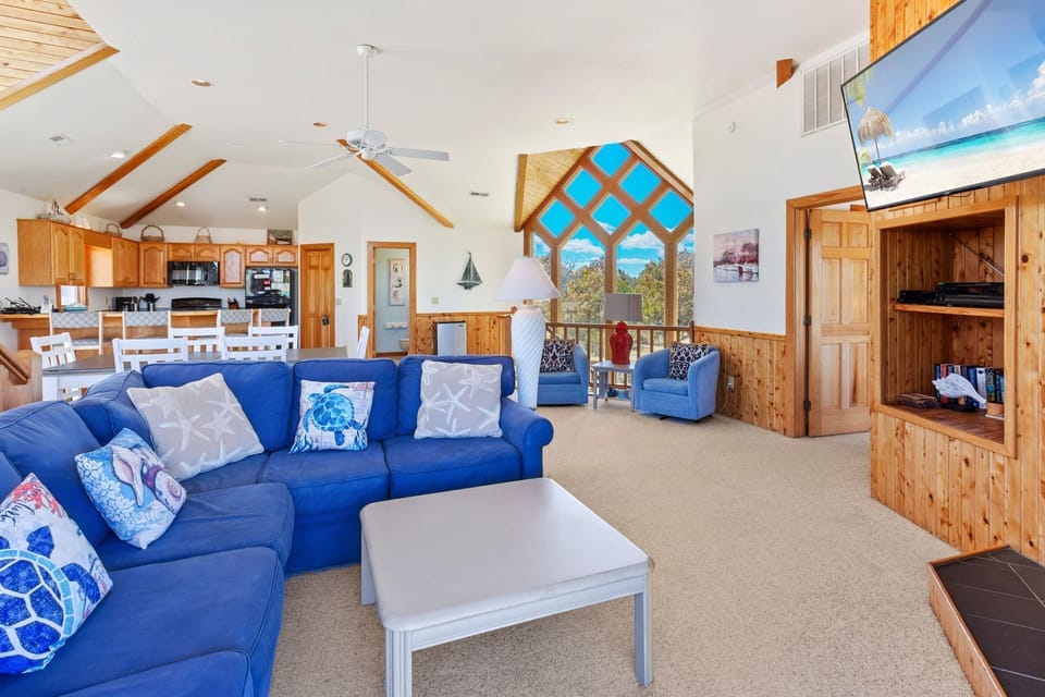 Relax in the spacious Living Area with high ceilings and plenty of natural light!