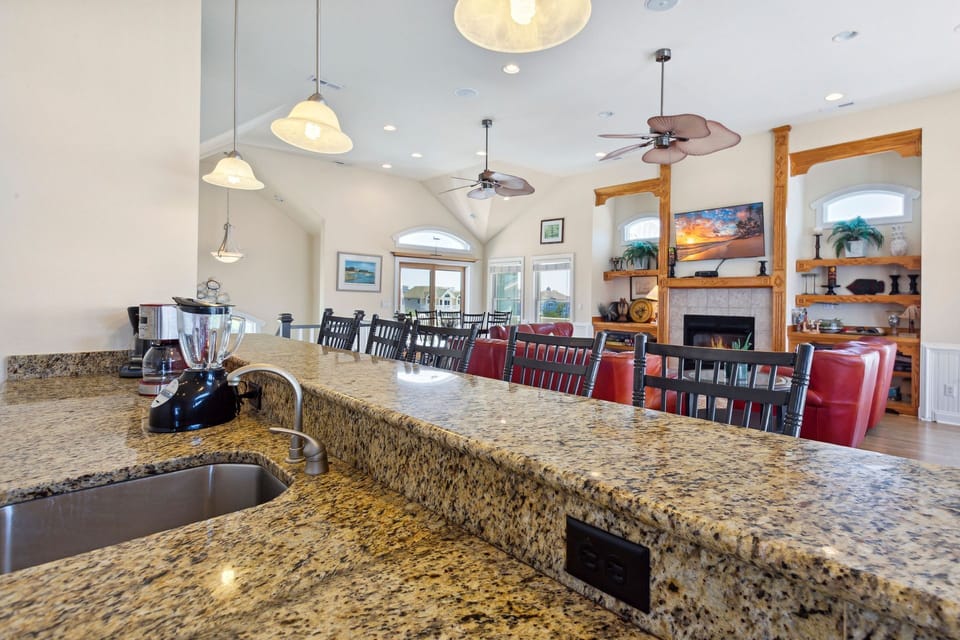 Whip up a delicious meal in the Modern Kitchen with stainless steel appliances, 2 Refrigerators, 2 Dishwashers, 2 Microwave Ovens, a Range, and a Wine Cooler. (Note: fireplace not for guest use)