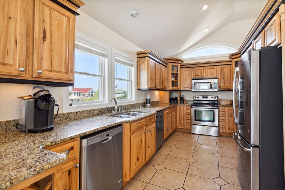Whip up a delicious meal in the Modern Kitchen with stainless steel appliances, 2 Refrigerators, 2 Dishwashers, 2 Microwave Ovens, a Range, and a Wine Cooler.
