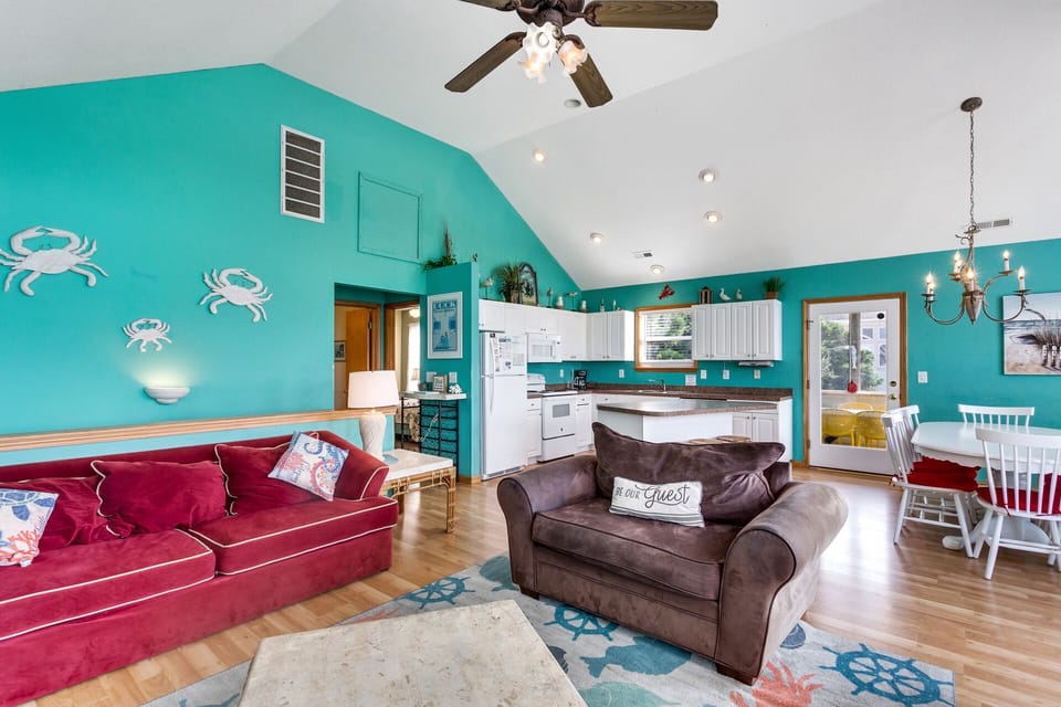 Relax in the spacious Living Area with bright decor and high ceilings.