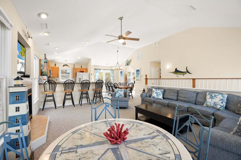 The open-concept living area features vaulted ceilings, abundant natural light, and comfortable seating for the whole family.