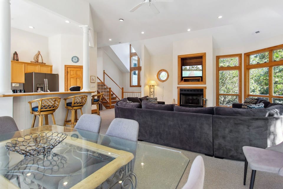Relax in the spacious Living Area with high ceilings and lots of natural light. (Please note: Fireplace is not for guests use)