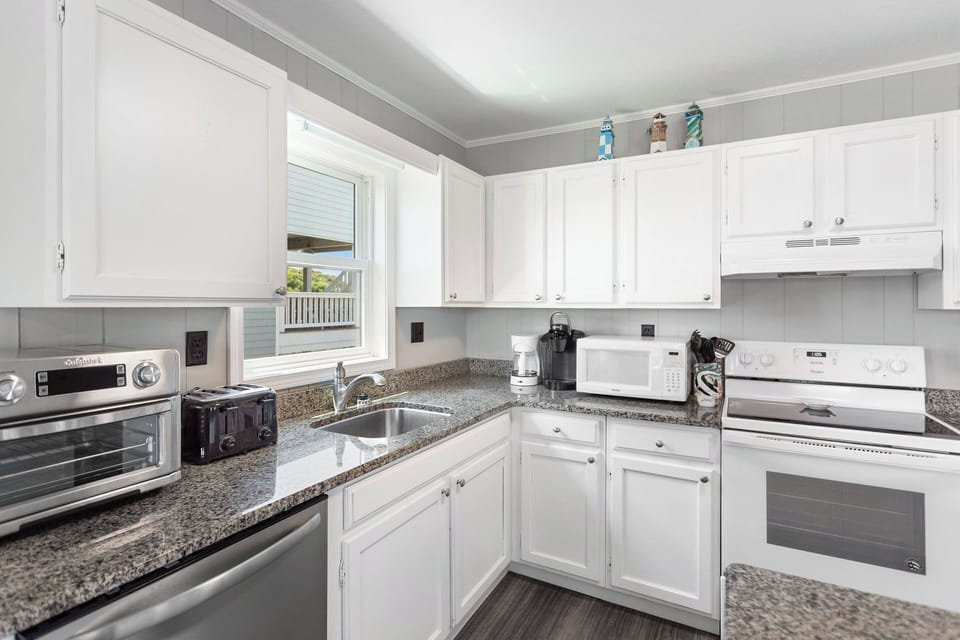 Whip up something delicious in the modern Kitchen with a flat-top stove and bar seating for 3!