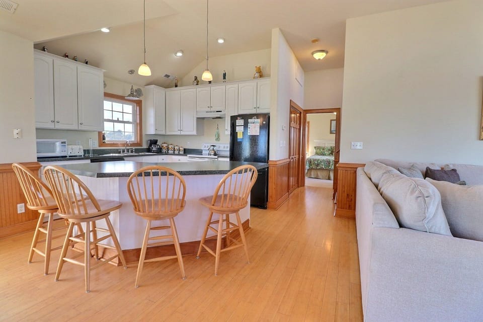 Whip up something delicious in the Kitchen with all modern appliances and a Breakfast Bar with seating for 4.