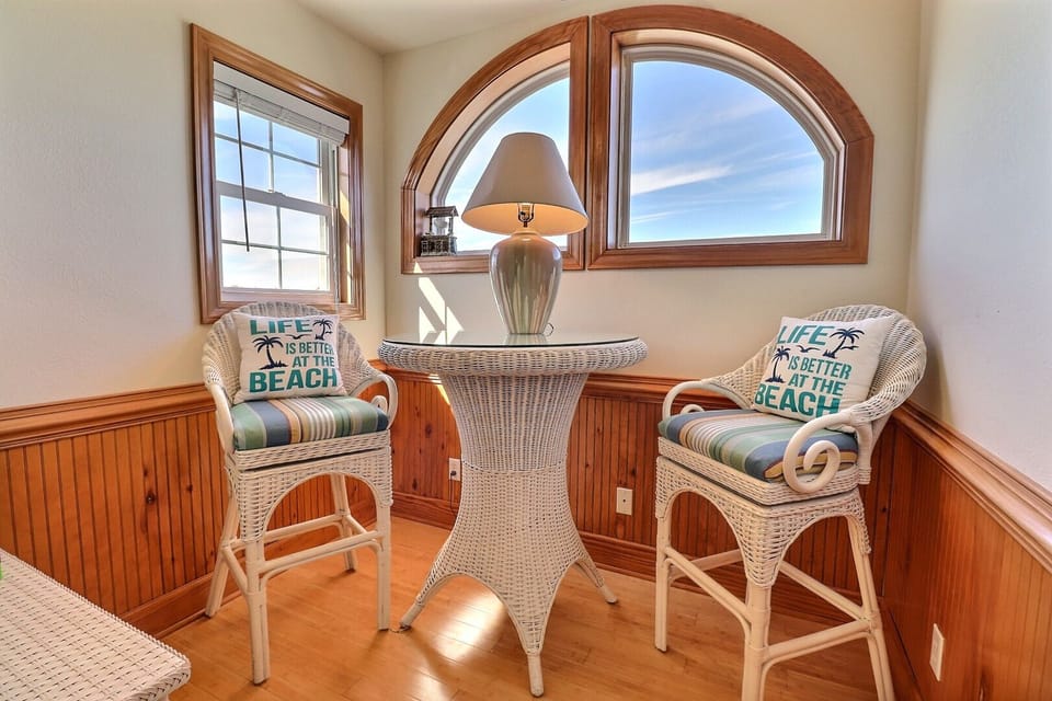 The Top-Level Sitting Area is ideal for card games, breakfasts, or relaxing with your favorite beach read.