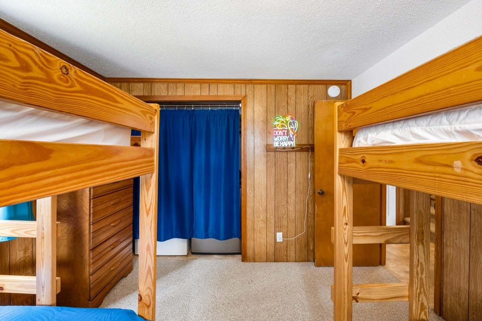 The ground-level bunk bedroom features two sets of bunk beds, perfect for younger guests.