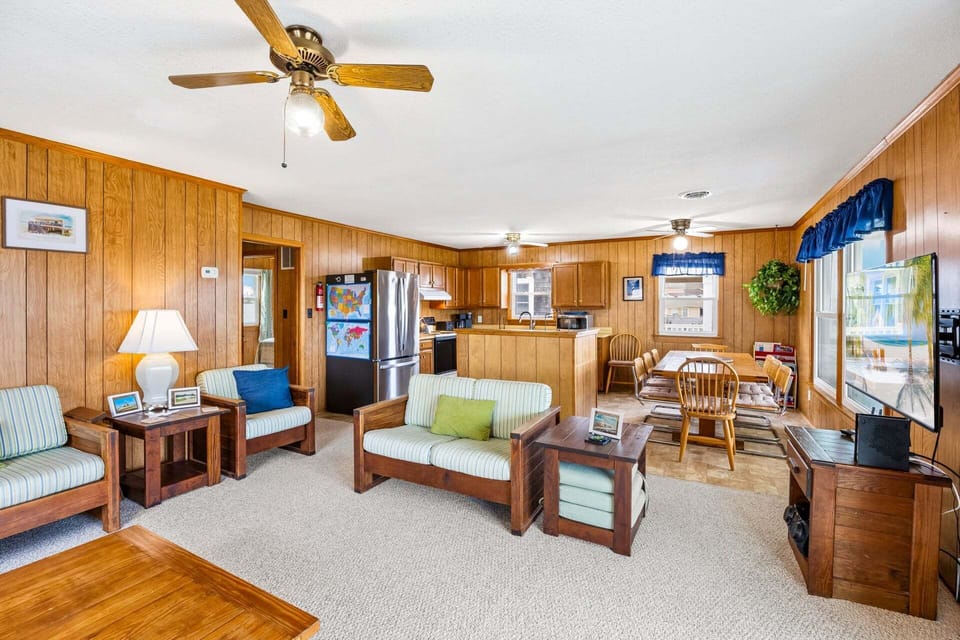 The bright and inviting living area features comfortable seating and classic nautical décor.