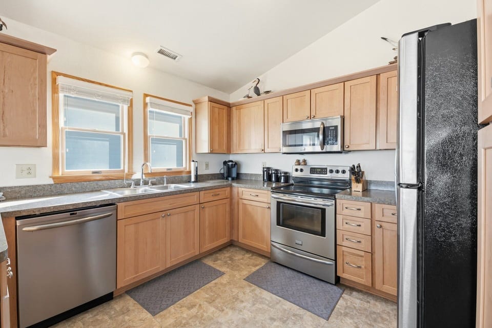 The fully equipped kitchen features modern appliances and ample counter space.