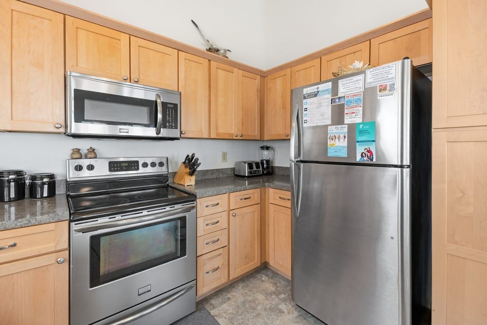 The fully equipped kitchen features modern appliances and ample counter space.