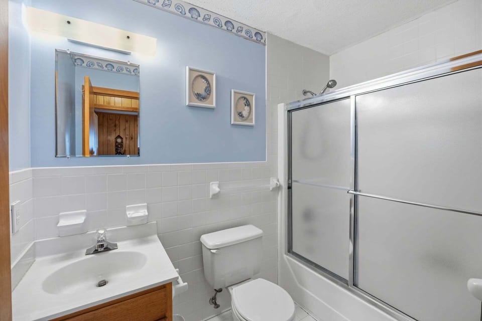 The shared hallway bathroom features a convenient tub and shower combination.