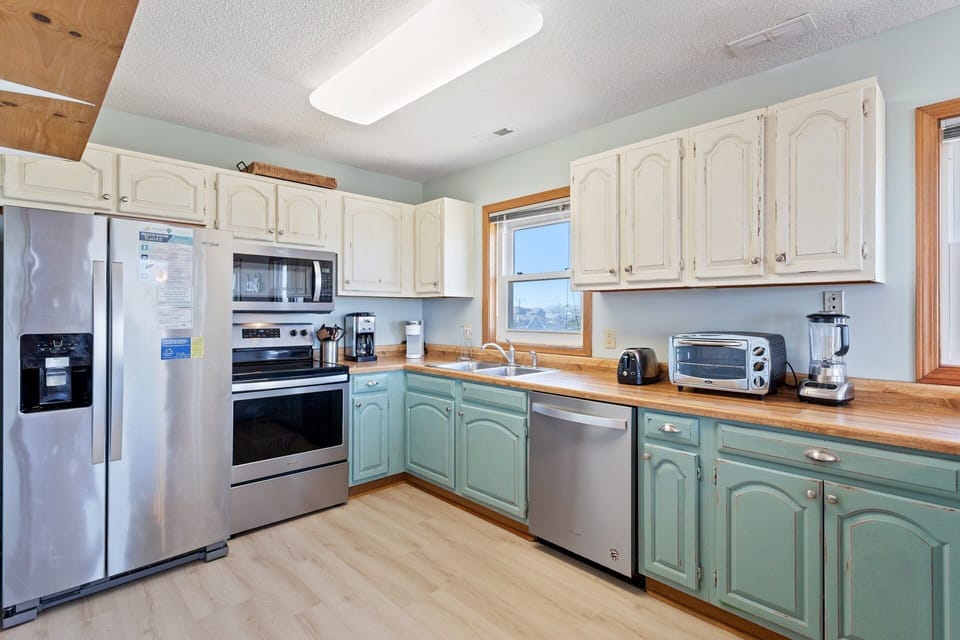 The spacious kitchen is equipped with modern appliances and ample counter space, making meal prep easy and enjoyable.