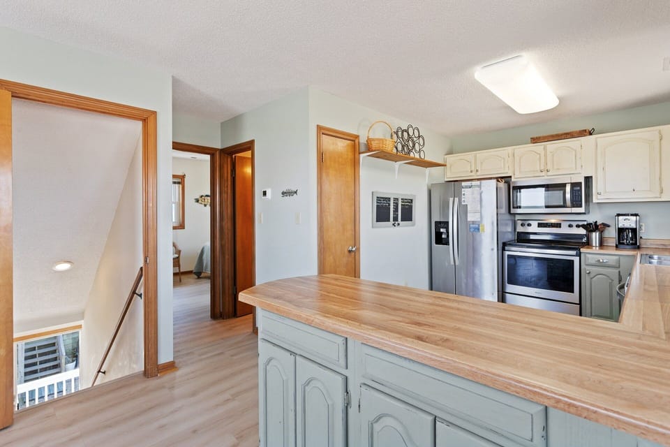 The spacious kitchen is equipped with modern appliances and ample counter space, making meal prep easy and enjoyable.
