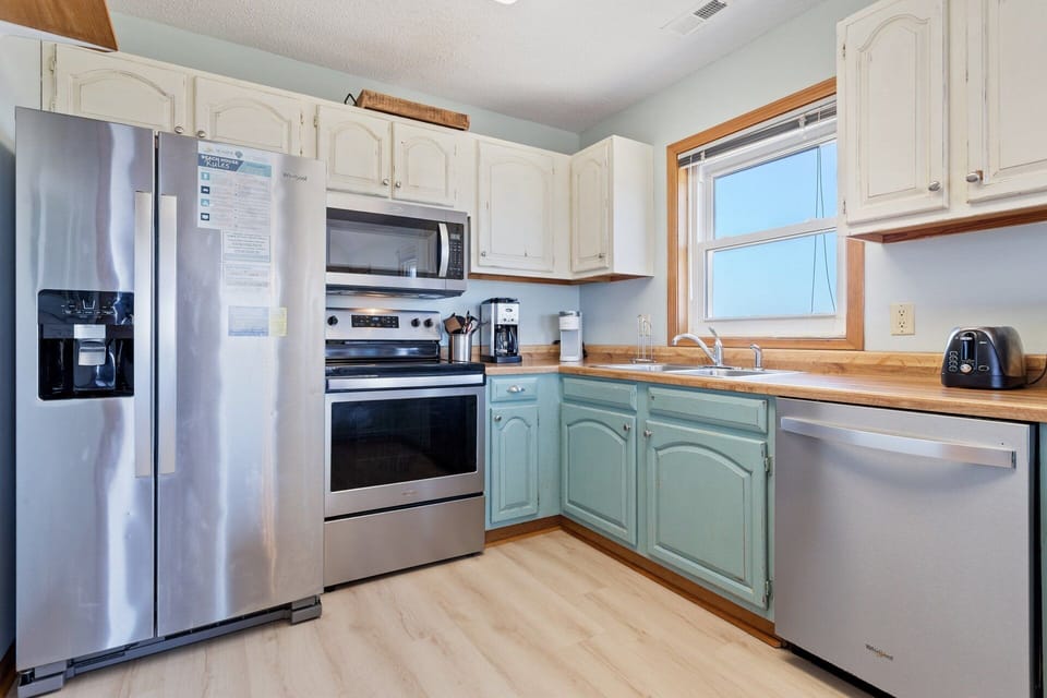 The spacious kitchen is equipped with modern appliances and ample counter space, making meal prep easy and enjoyable.