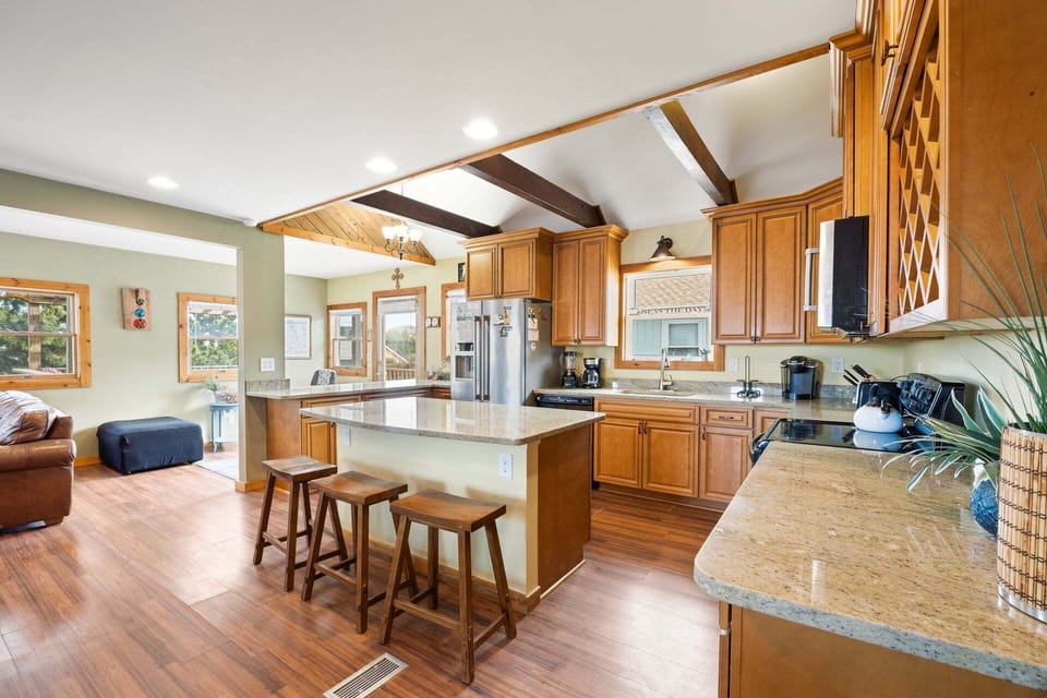 The open-concept kitchen is fully equipped with modern appliances and ample space for meal preparation.