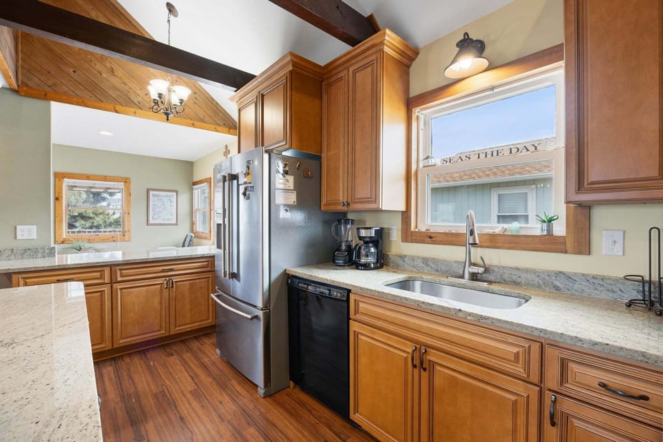 The open-concept kitchen is fully equipped with modern appliances and ample space for meal preparation.