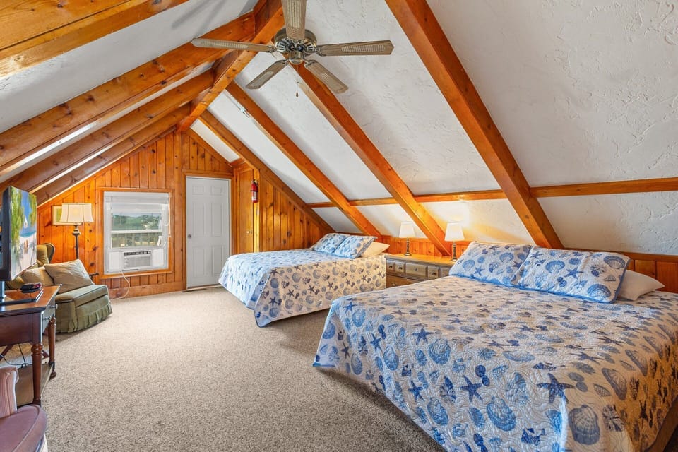 The Top Loft has 2 Queen Beds, a sitting area, and a TV for your comfort and convenience!