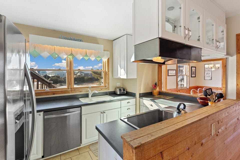 Impress the family with your cooking skills in the Kitchen with a coffee pot and modern appliances.