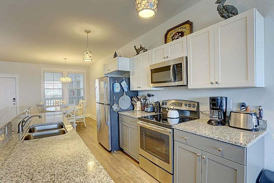 Prepare a delicious seafood feast in the spacious Kitchen with modern appliances, a double sink, and plenty of space to prepare something unforgettable.