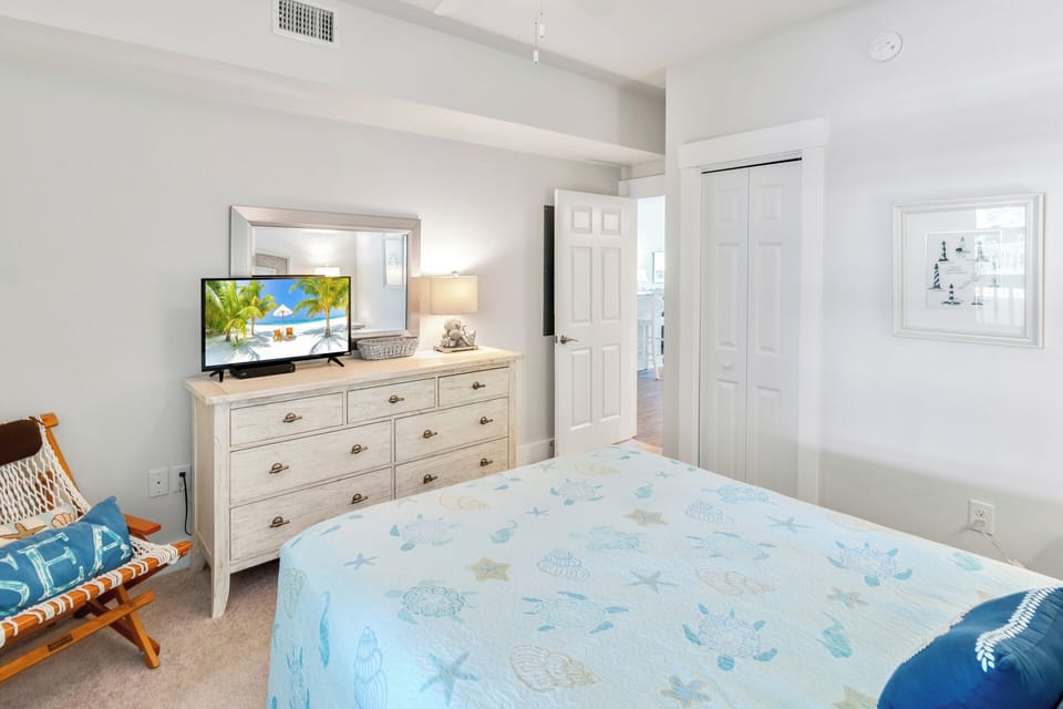 The other Queen Bedroom is just as cozy with a TV, ceiling fan, and access to the Full Bathroom in the hall.