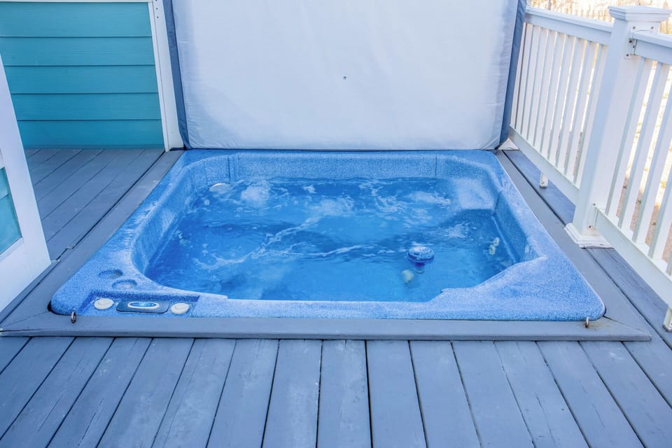 Oceanfront sun deck with hot tub, perfect for soaking under the stars.