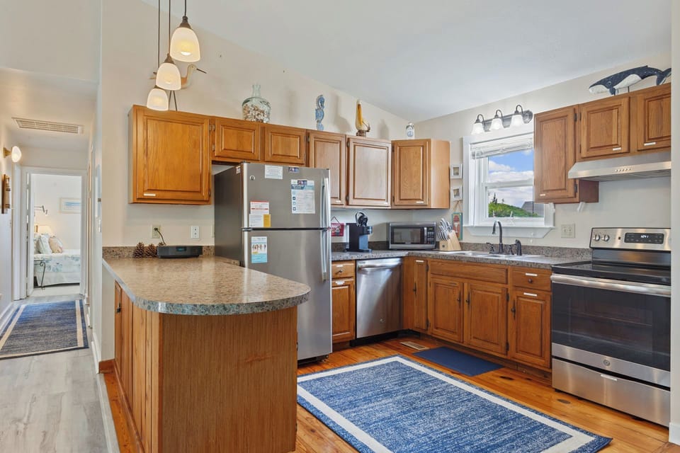 A fully-stocked kitchen with wood cabinetry, stainless steel appliances and plenty of counter space makes prepping your meal a breeze.