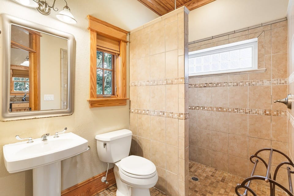 The main level full bathroom boasts a spacious tile shower for easy freshening up.