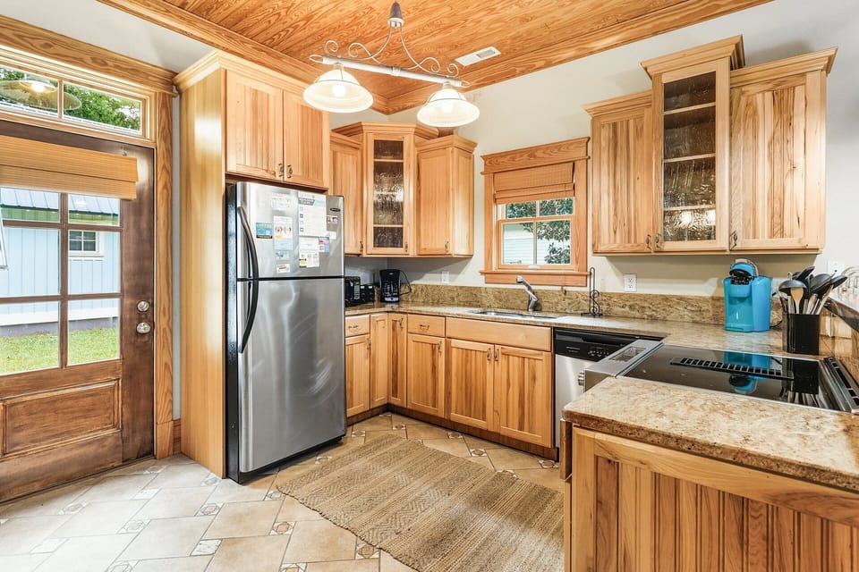 The fully equipped kitchen features stainless steel appliances, granite countertops, and everything you need for home-cooked meals.