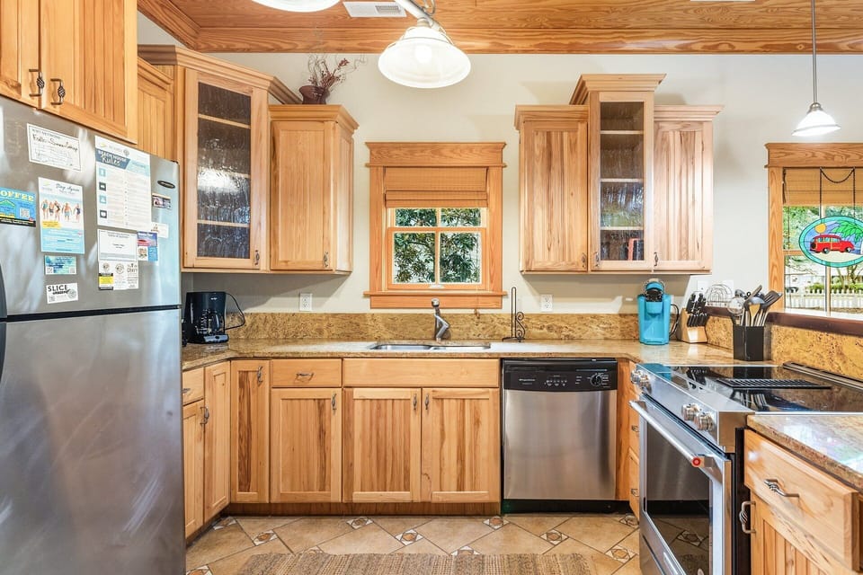 The fully equipped kitchen features stainless steel appliances, granite countertops, and everything you need for home-cooked meals.