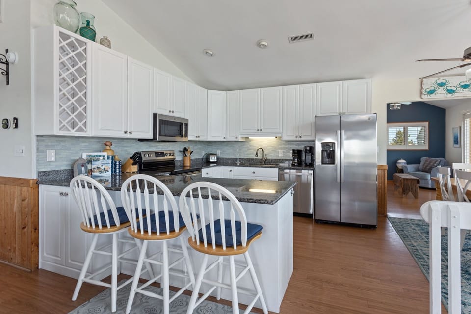 Whip up something delicious in the centralized fully equipped kitchen with beautiful granite countertops.
