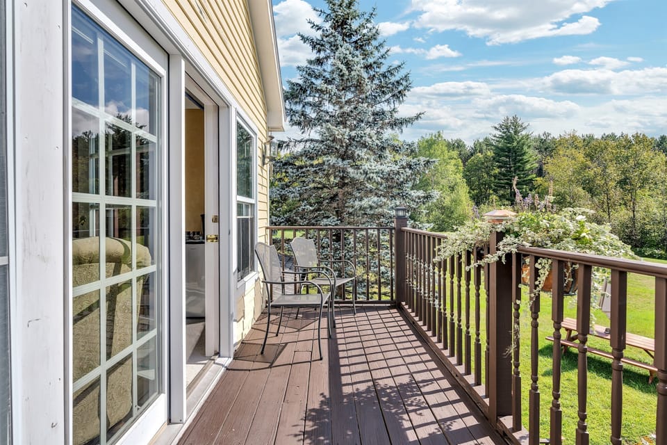 private balcony with views of backyard, forest, and mountains