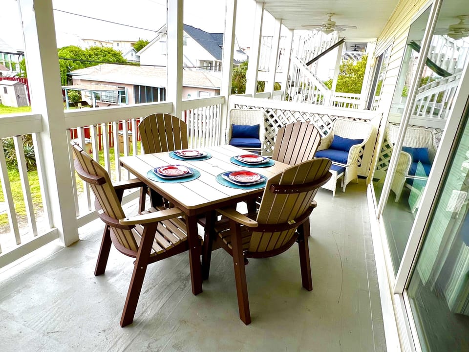 Spacious front deck with dining and sitting areas