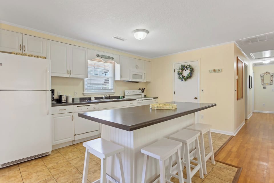 The Kitchen with a convenient Counter Bar is perfect for dining and snacking.