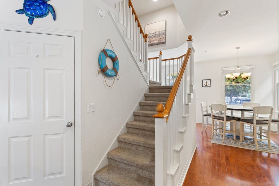 Charming townhouse with bright coastal décor and an easy-to-spot mermaid accent, welcoming you to your OBX getaway.