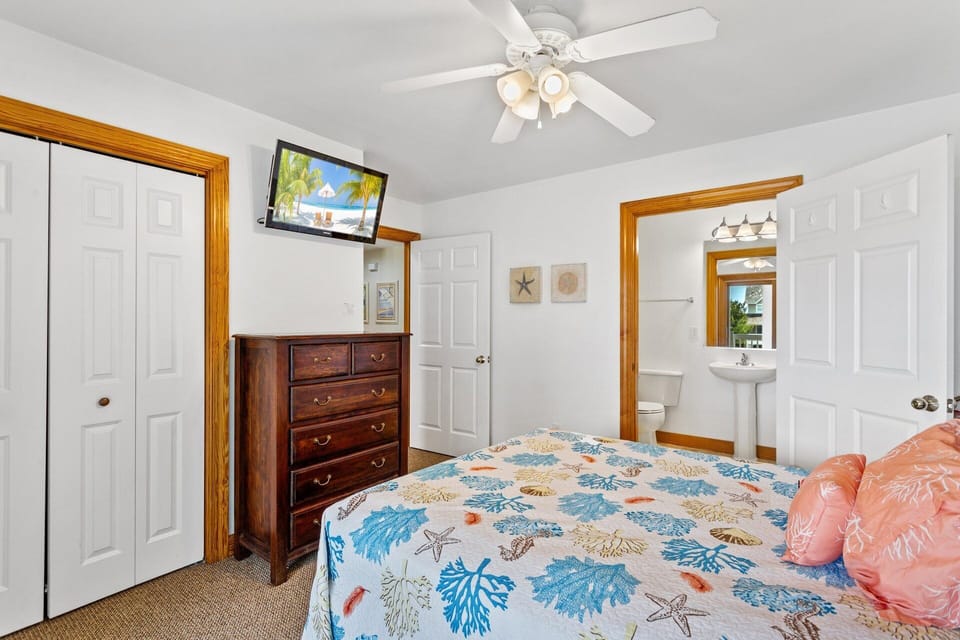 Queen Bedroom w/Deck: Relax in this queen suite with a private bath and doors to the covered deck.