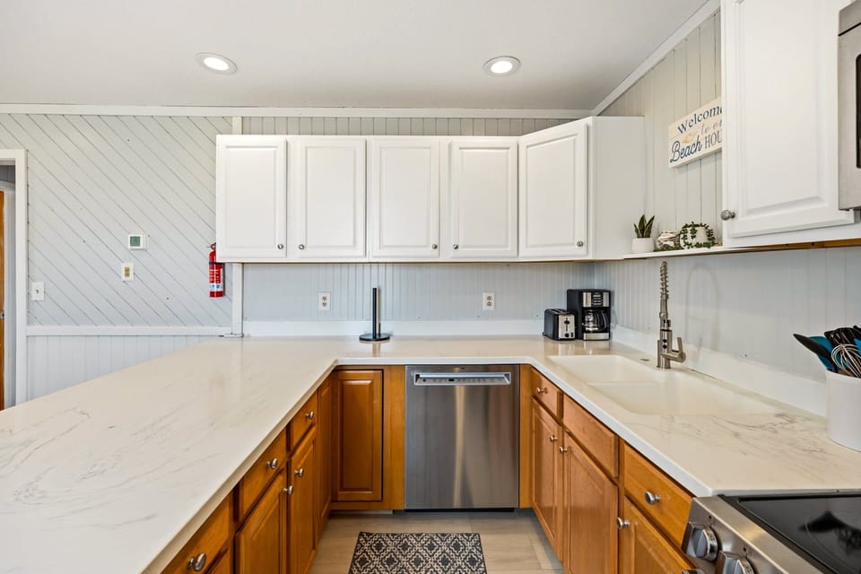 Kitchen: Cook with ease in the fully equipped kitchen featuring modern appliances and a dishwasher.